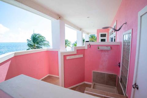 The image displays a unique and picturesque outdoor shower area