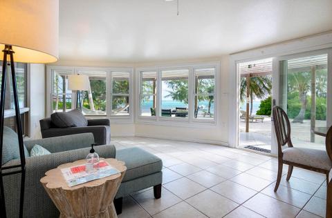 The image shows a well-lit beachfront living room