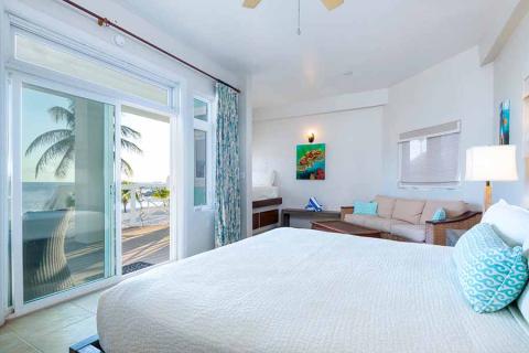 This image features a bright and airy beachfront hotel room