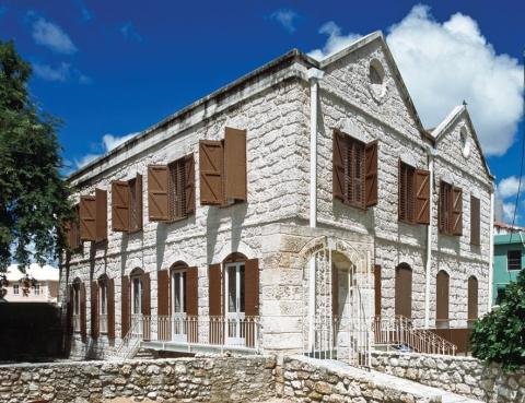 This image shows a historical stone building with a classical architectural style