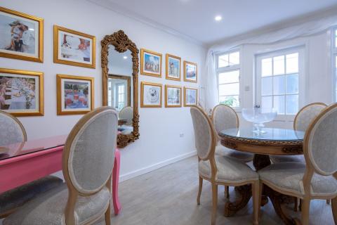 The image displays a bright and elegantly decorated room, possibly a dining area