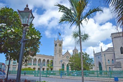 This image depicts a splendid architectural view likely taken in a tropical or sub-tropical location, judging by the palm trees and foliage