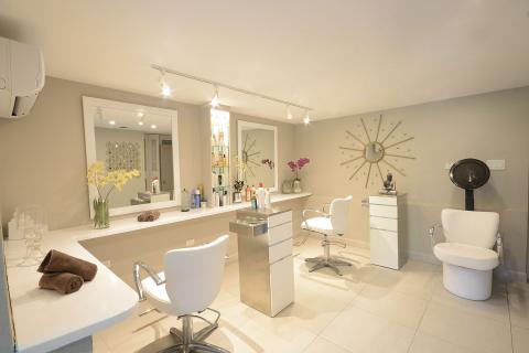 This image shows a modern and spacious hair salon interior