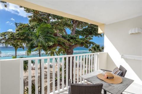 This image shows a balcony with a scenic oceanfront view