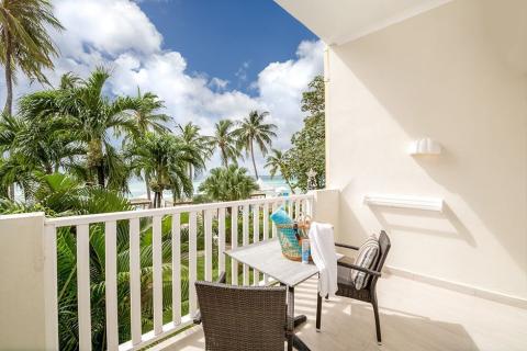This image shows a sunny, beach-facing balcony