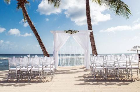 This image shows a beautiful beach wedding setup