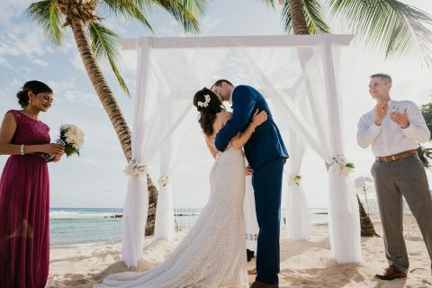 This image captures a beautiful beach wedding scene