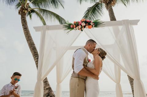 This image depicts a beach wedding scene