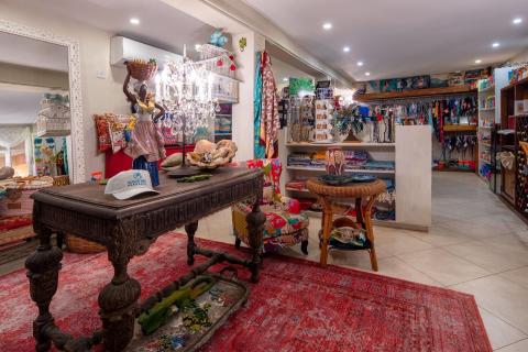 The image shows the interior of a vibrant and eclectic boutique shop