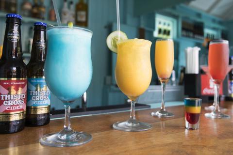 This image features a variety of beverages displayed on a bar counter