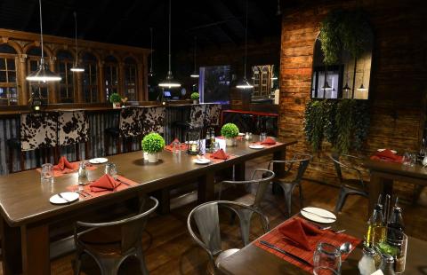 This image shows the interior of a restaurant designed with a rustic and cozy aesthetic