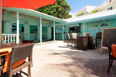 This image shows an inviting outdoor bar area associated with a casual dining restaurant