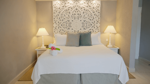 The image features a neatly arranged bedroom