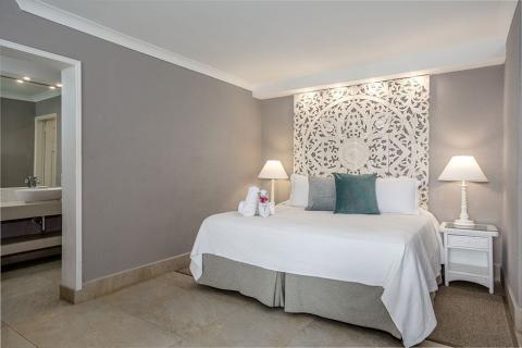 This image depicts a modern and neatly arranged bedroom