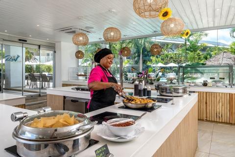 This image depicts a bright and modern outdoor cooking area at a restaurant