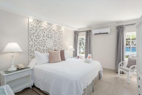 This image shows a neatly arranged bedroom with a soothing and elegant design