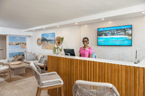 This image shows a welcoming reception area of what appears to be a beach resort or similar travel-related business