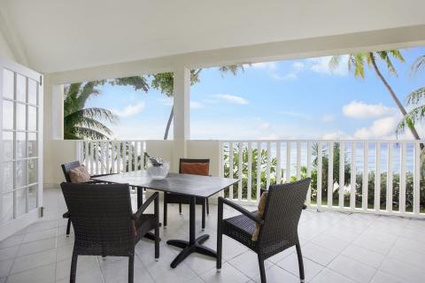 This image shows a spacious balcony with a view of the ocean