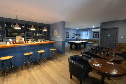 This image features a stylish bar and lounge area