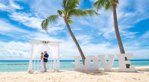 This image features a beautiful beach wedding scene