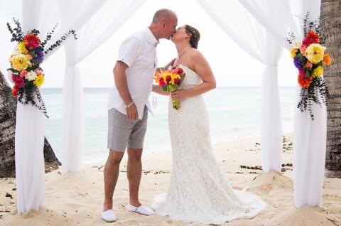 This image depicts a wedding ceremony taking place on a beach