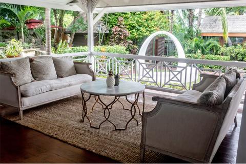 This image shows a serene outdoor living space on a covered porch