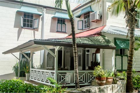 This image shows a tropical-style building featuring various architectural elements typical of a warm climate