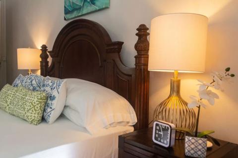 The image shows a well-decorated bedroom with soothing lighting