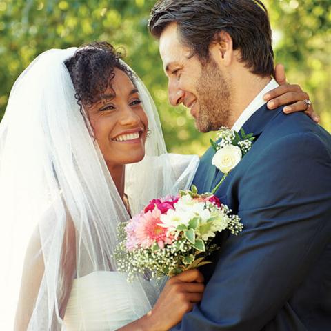 The image depicts a joyful wedding scene featuring a bride and groom