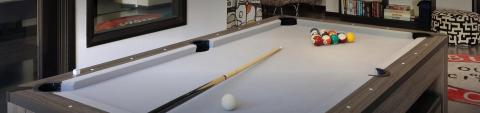 The image shows an indoor billiards or pool table set up for a game