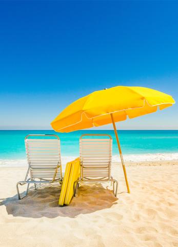 This image features a bright and inviting beach scene