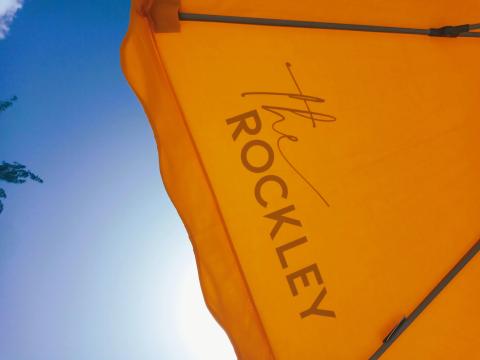 This image shows a portion of a bright yellow beach umbrella
