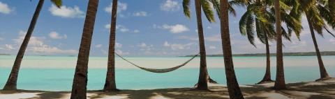 This image features a tranquil tropical beach scene