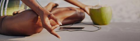 The image shows a person lying down outdoors, enjoying a relaxing moment in the sun