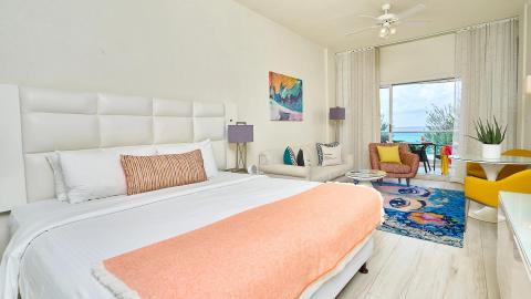 This image shows a bright and modern beachfront bedroom