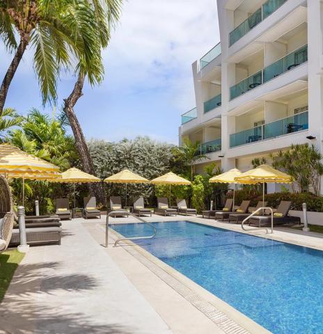 This image shows a luxurious outdoor pool area of a hotel or resort