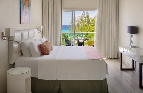 This image features a neatly arranged hotel room with a contemporary design