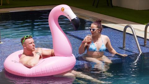 This image shows two people enjoying themselves in a swimming pool